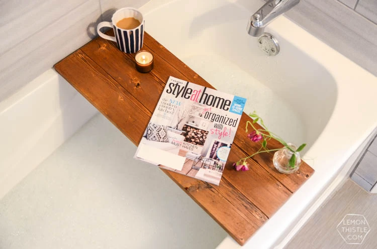 A beautifully stained wooden bathtub tray holding a book and coffee, making it a perfect spa-like small wood project to build and sell.